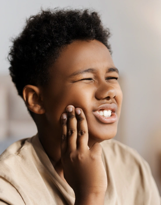Child experiencing a toothache requiring prompt dental care