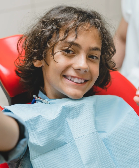 Smiling child enjoying a comfortable pediatric dental visit