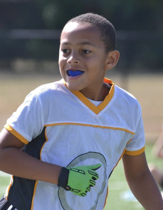 Active child wearing a mouthguard for sports protection