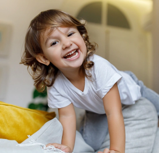 Smiling young girl enjoying a playful moment indoors